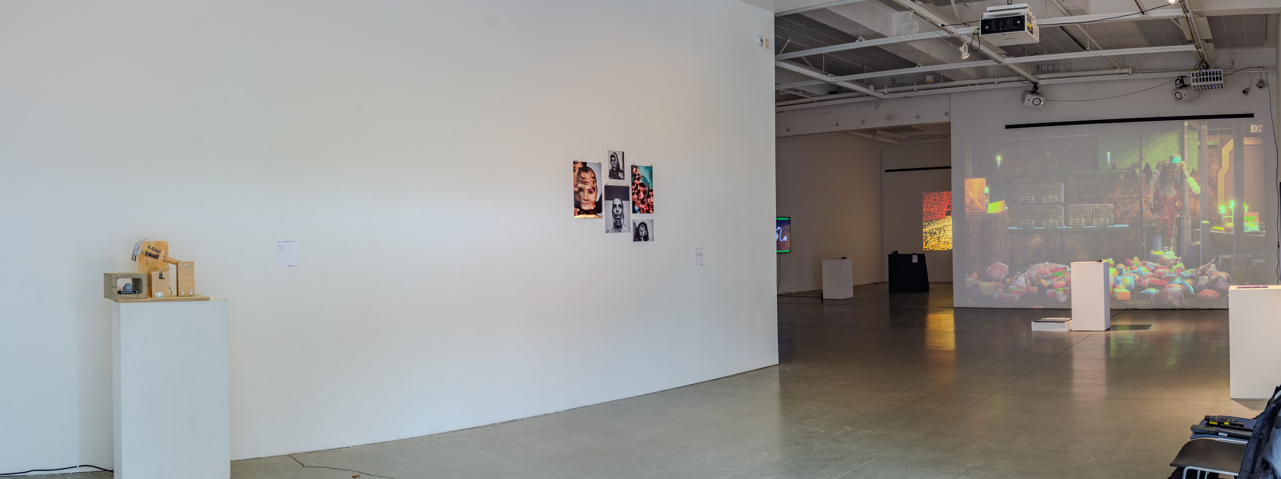 Gallery interior showing art pieces among white walls.